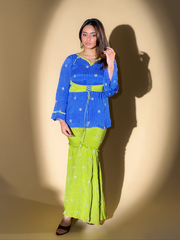 Woman wearing a blue top and green skirt against a yellow background