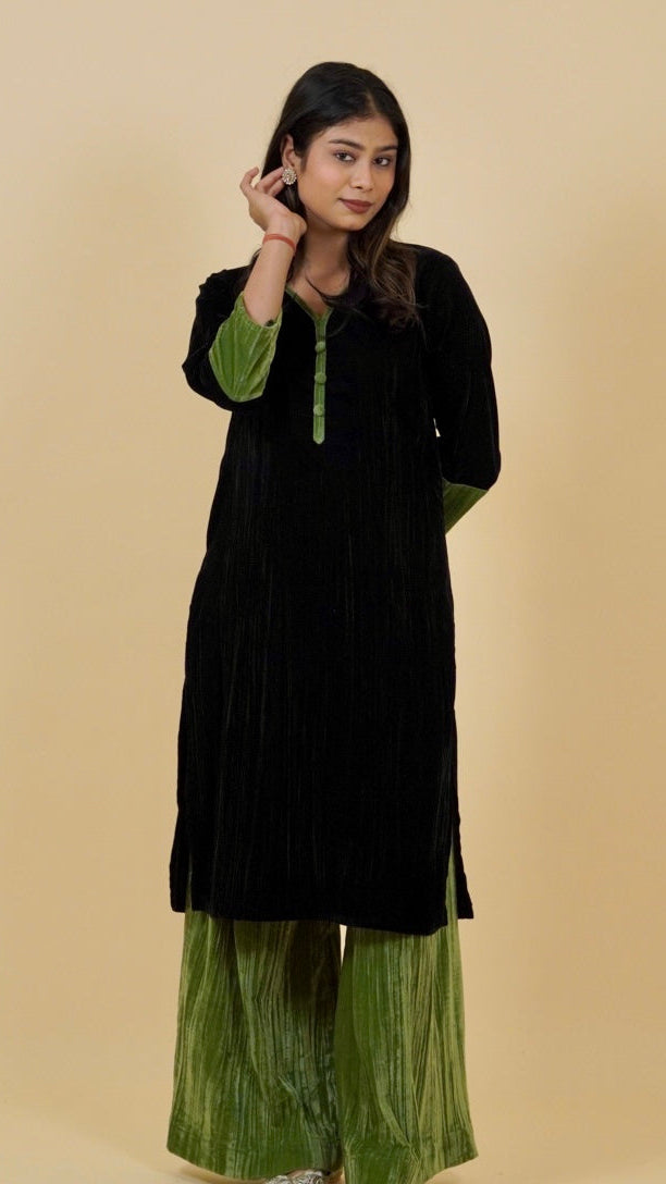 Woman wearing a black and green traditional outfit on a beige background